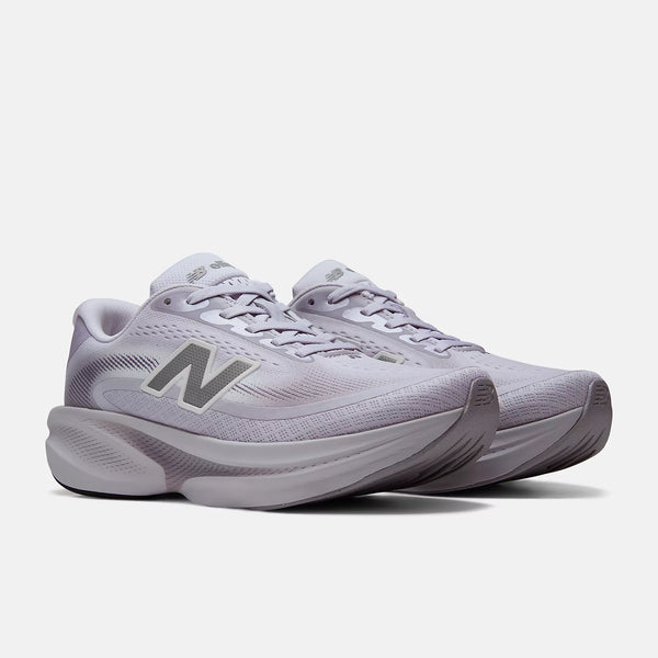 A pair of New Balance running shoes in a light lavender-gray colorway, featuring the signature 'N' logo on the side, set against a clean, light gray background.