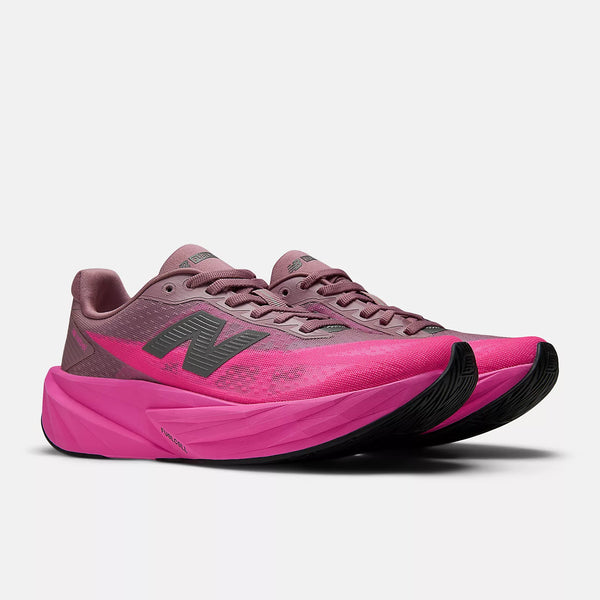 Pink running shoes with black soles on a white background