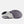 The outsole of a sneaker shown from a side profile view, featuring a white midsole with a dark gray and black treaded rubber outsole.