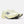 A New Balance running shoe in a pale cream-yellow colorway, featuring a textured mesh upper, matching laces, a thick sculpted foam midsole, and a metallic silver 'N' logo on the side.