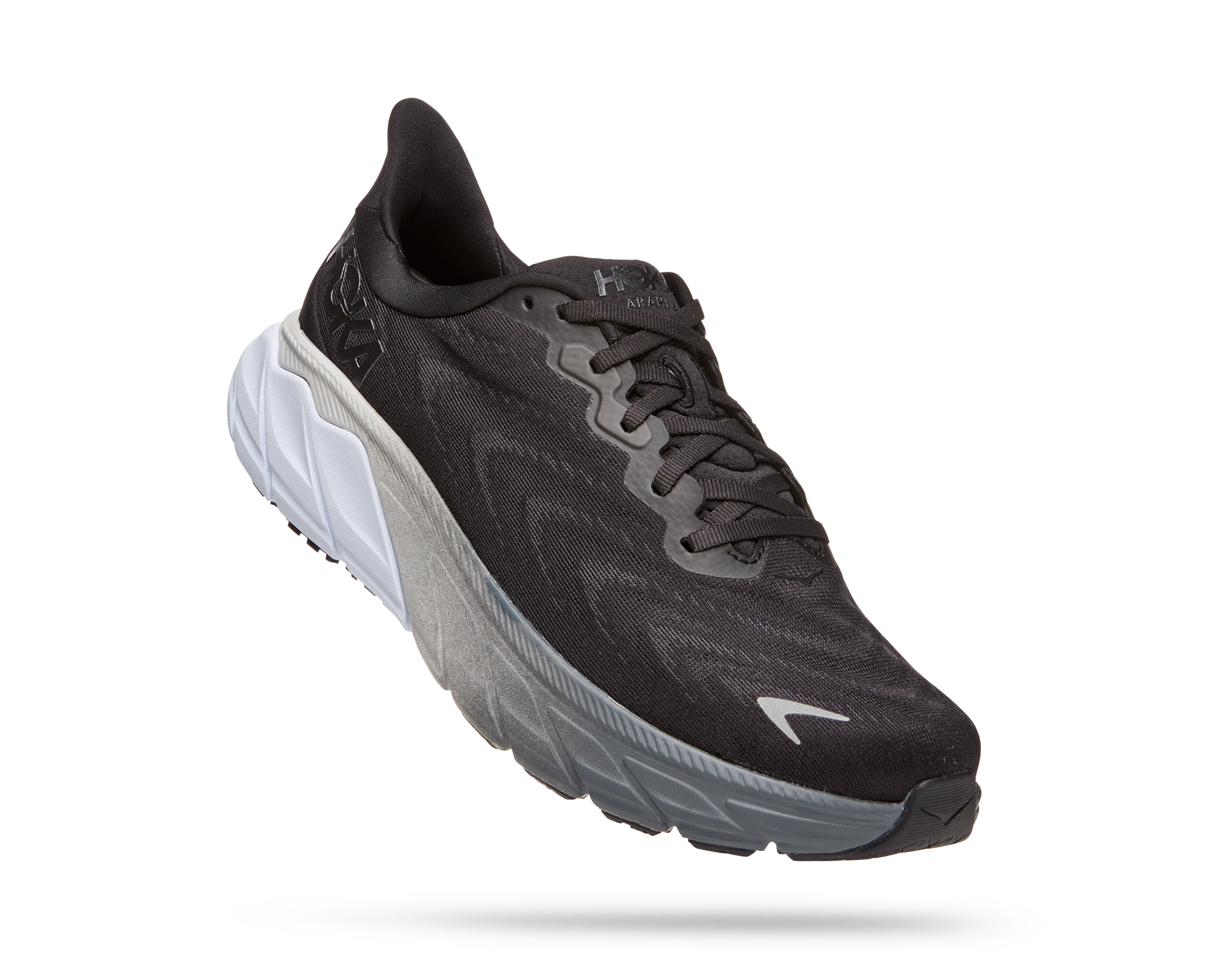 Lateral angled view of the Men's Arahi 6 by HOKA in the wide 2E width, color Black/White