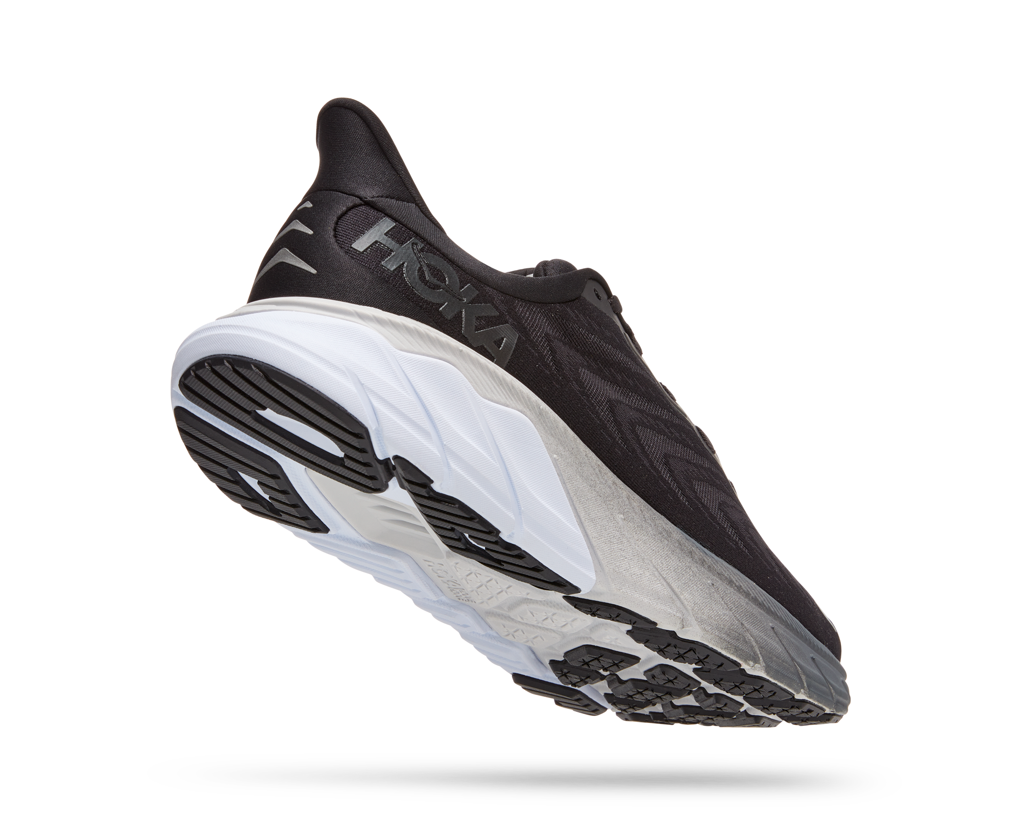 Back angled view of the Men's Arahi 6 by HOKA in the wide 2E width, color Black/White