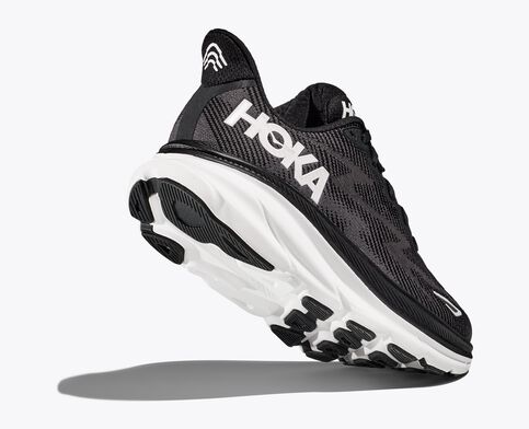 Back angled view of the Men's HOKA Clifton 9 in the wide 2E width - color Black/White