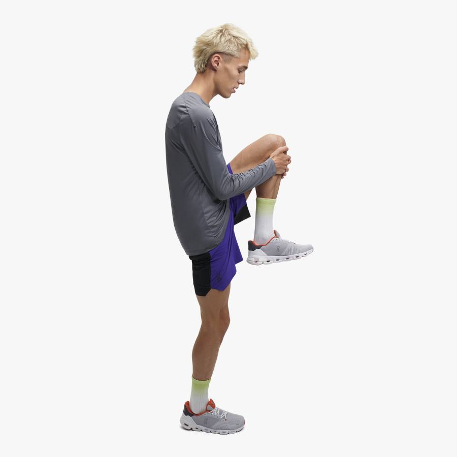 Side view of a male model wearing the Performance Long Tee from ON in the color Rock
