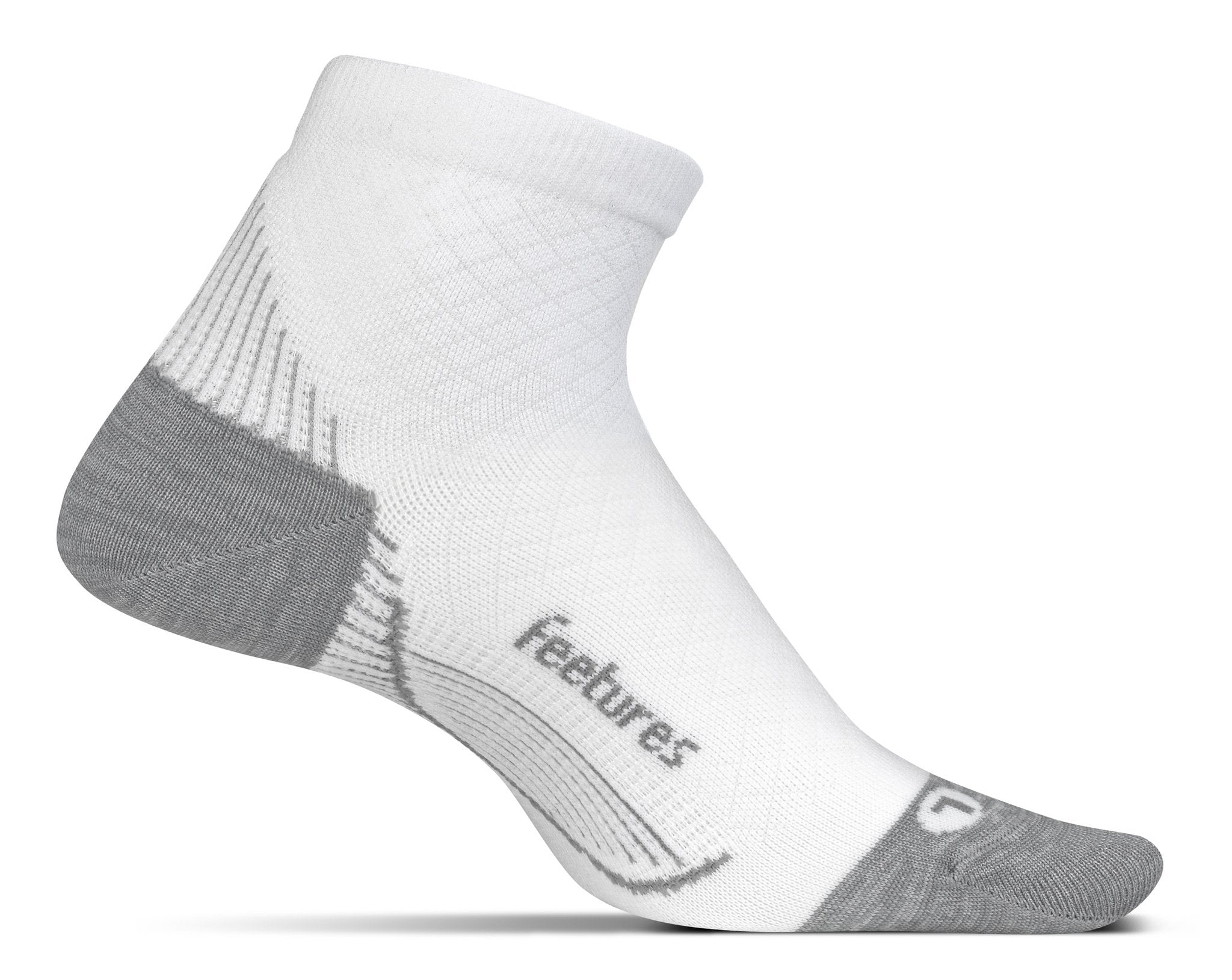 A medial view of the Feetures Plantar Fasciitis Quarter Sock (left foot) in the color white.