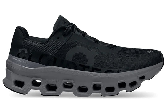 Lateral view of the Women's ON Cloudmonster in Black/Magnet