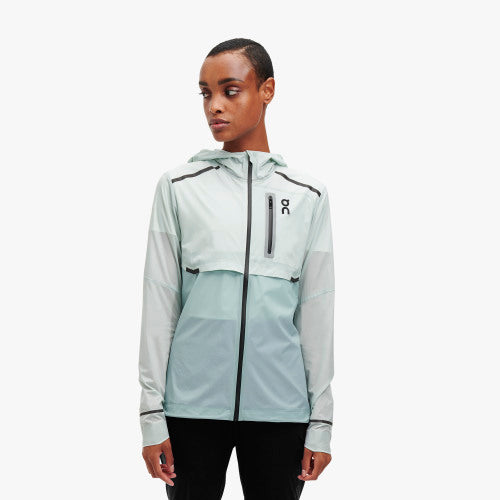 Front view of a model wearing the Women's Weather Jacket by ON in the color Surf/Sea