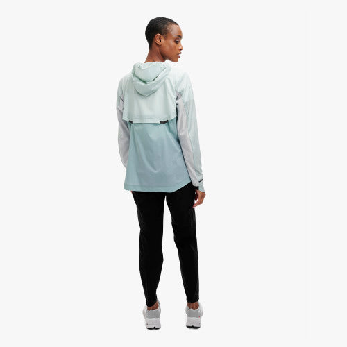 Back view of a model wearing the Women's Weather Jacket by ON in the color Surf/Sea