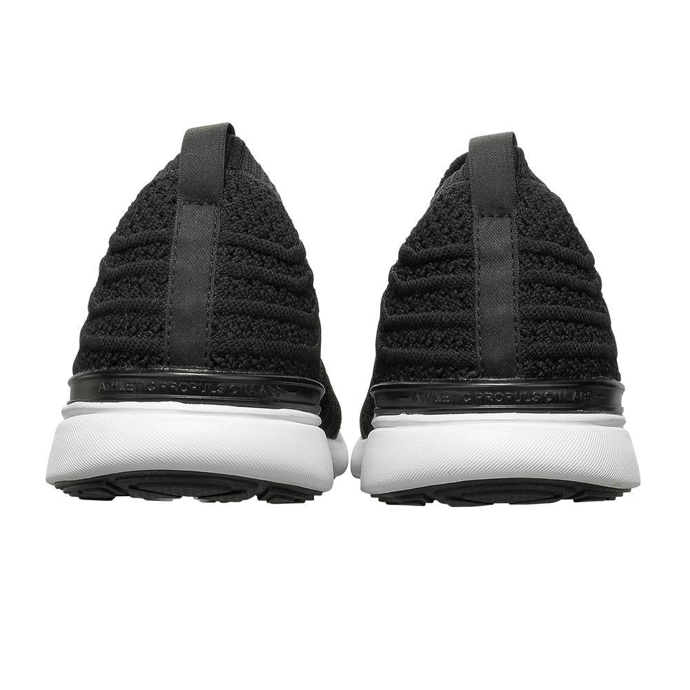 Men's APL Tech Loom Wave in Black and White with back view of both heels of the APL shoe