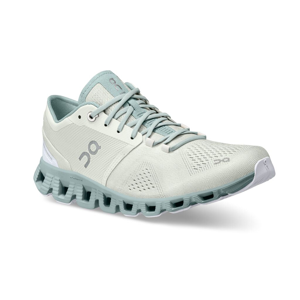 Angled front view of the Women's Cloud X right shoe in the color Aloe/Surf