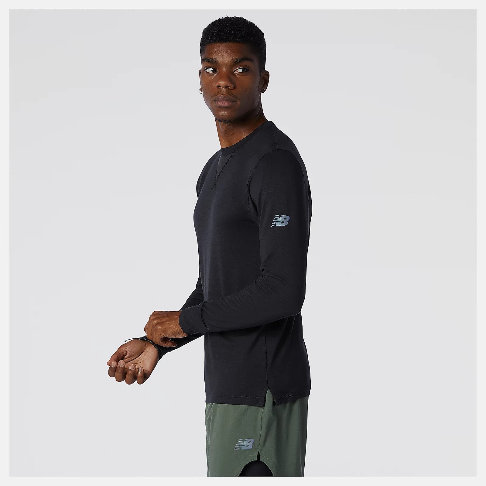 Side view featuring the New Balance logo of the Men's Q Speed 1NTRO Long Sleeve in black