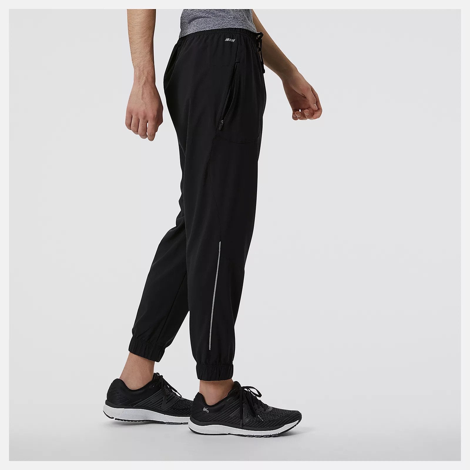 Side view of the Men's Impact Run Woven Pant by New Balance in Black