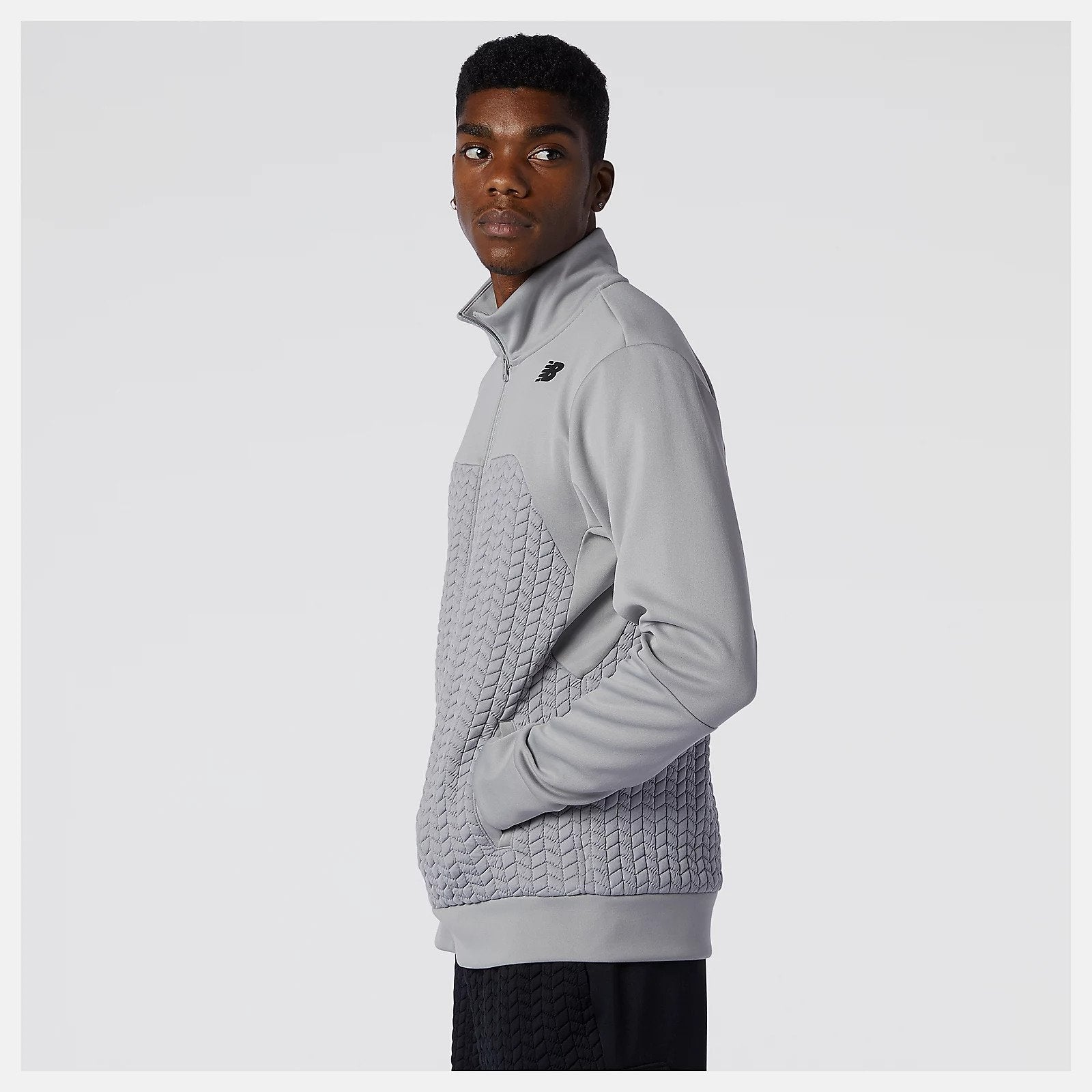 Side view of a model wearing the Men's Heat Loft Full Zip by New Balance in the color Alloy