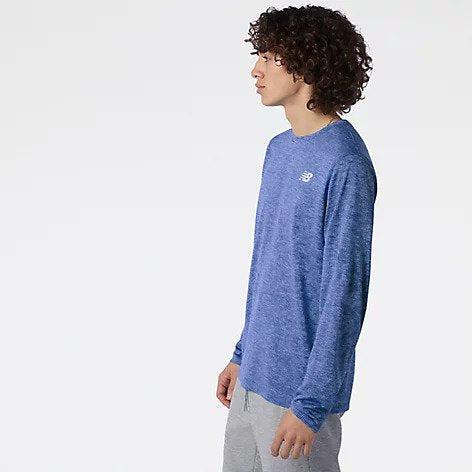 Side view of a model wearing the Men's Tenacity Long Sleeve by New Balance in the color Serene Blue Heather