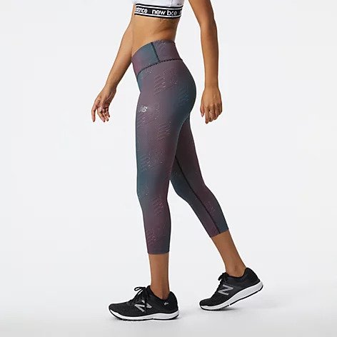 Side view of a model wearing the Women's Printed Accelerate Capri by New Balance in the color Black/Multi