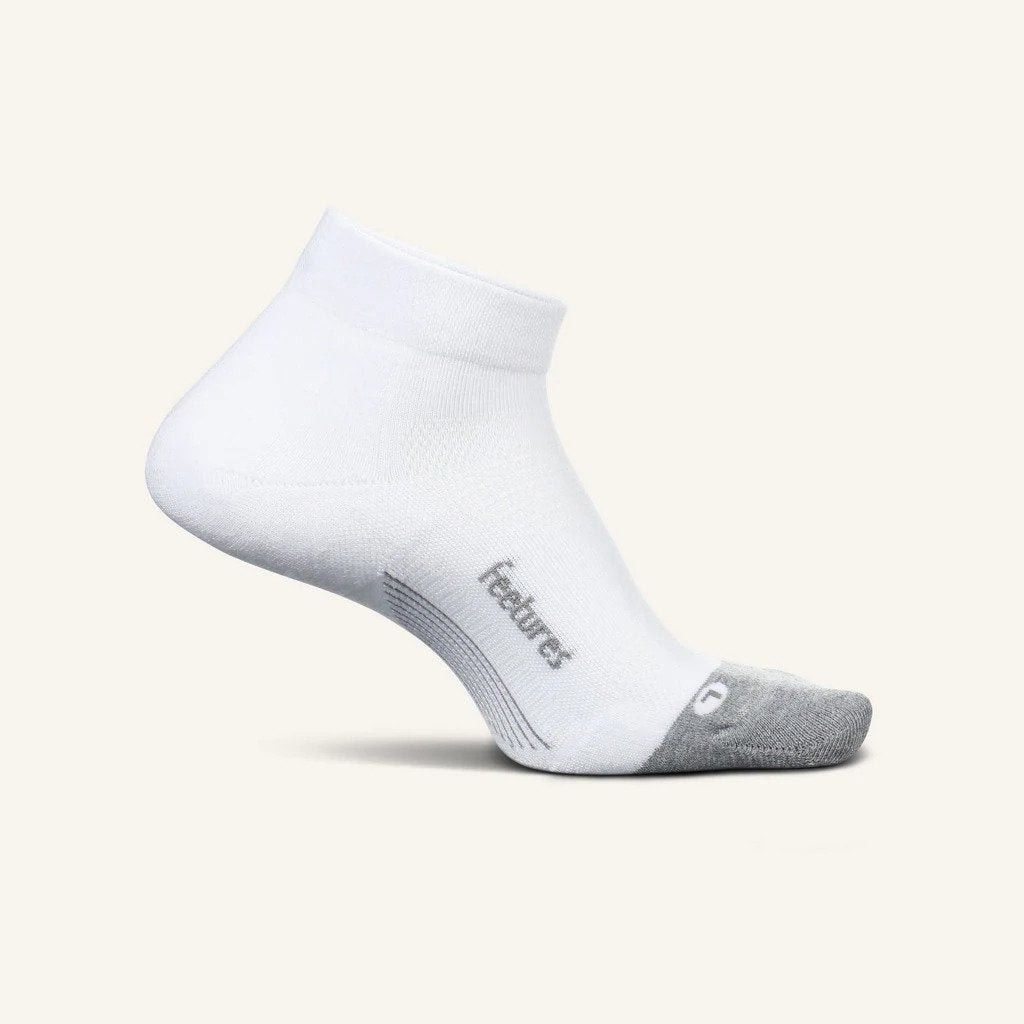 Medial view of the Feetures Elite Max cushion low cut no show tab sock in the color white