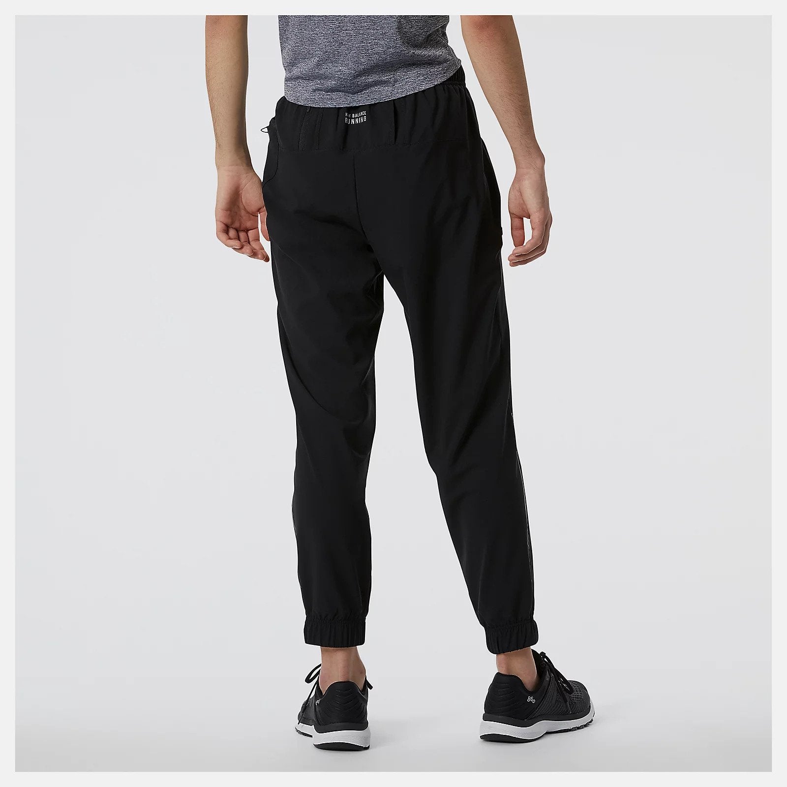 Back view of the Men's Impact Run Woven Pant by New Balance in Black