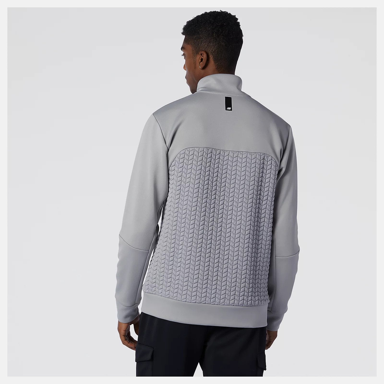 Back view of a model wearing the Men's Heat Loft Full Zip by New Balance in the color Alloy