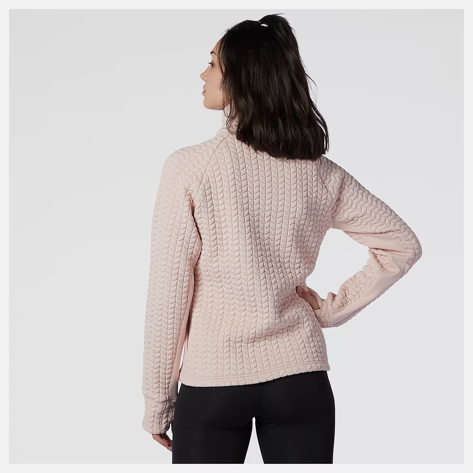 Back view of a model wearing the Women's Heatloft Athletic Jacket in the color Oyster Pink