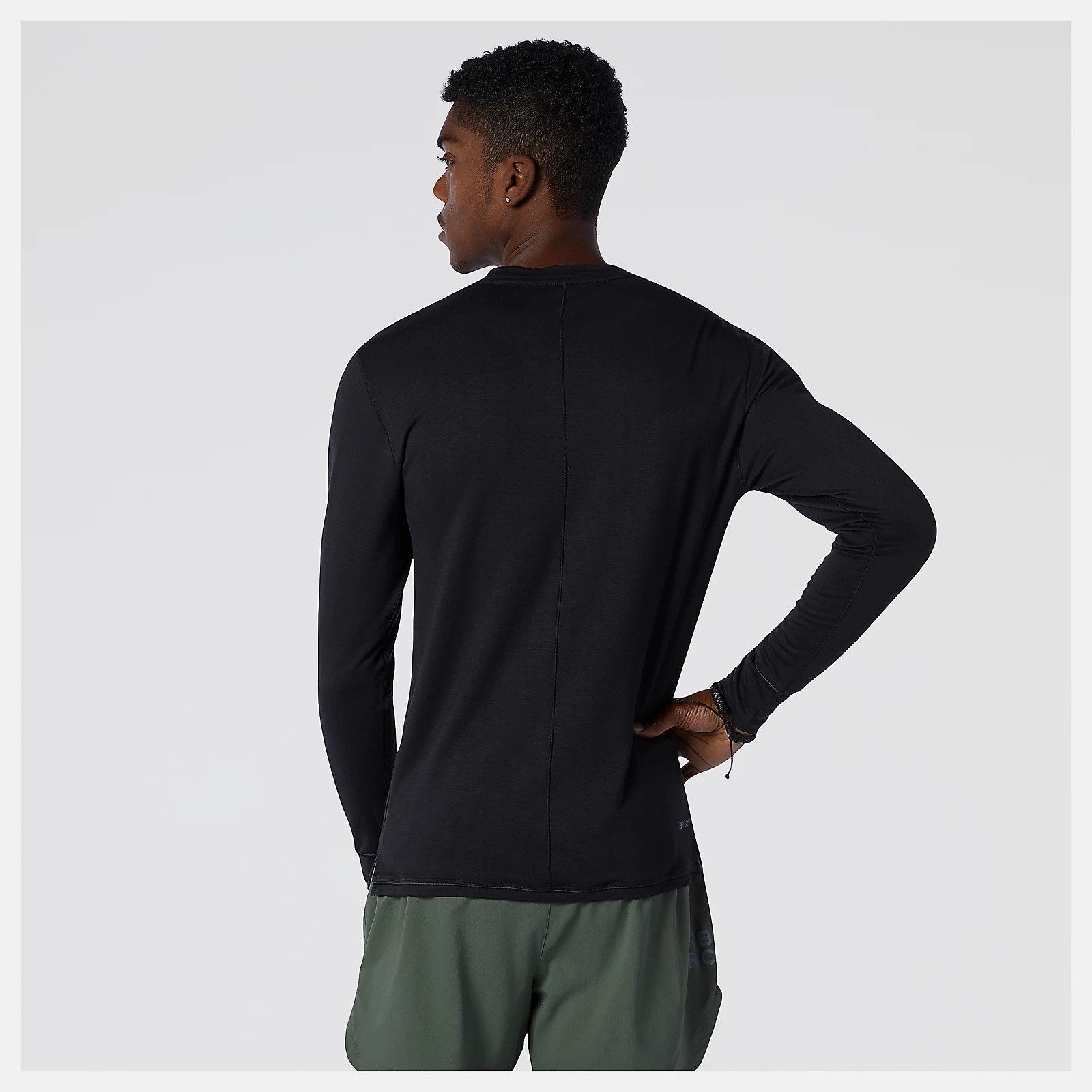 Back view of a model wearing the Men's Q Speed 1NTRO Long Sleeve in black