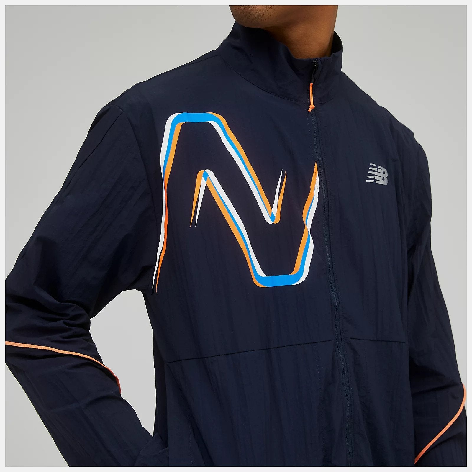 Front zoomed in view of a model wearing the Men's Graphic Impact Run Packable Jacket by New Balance in Eclipse