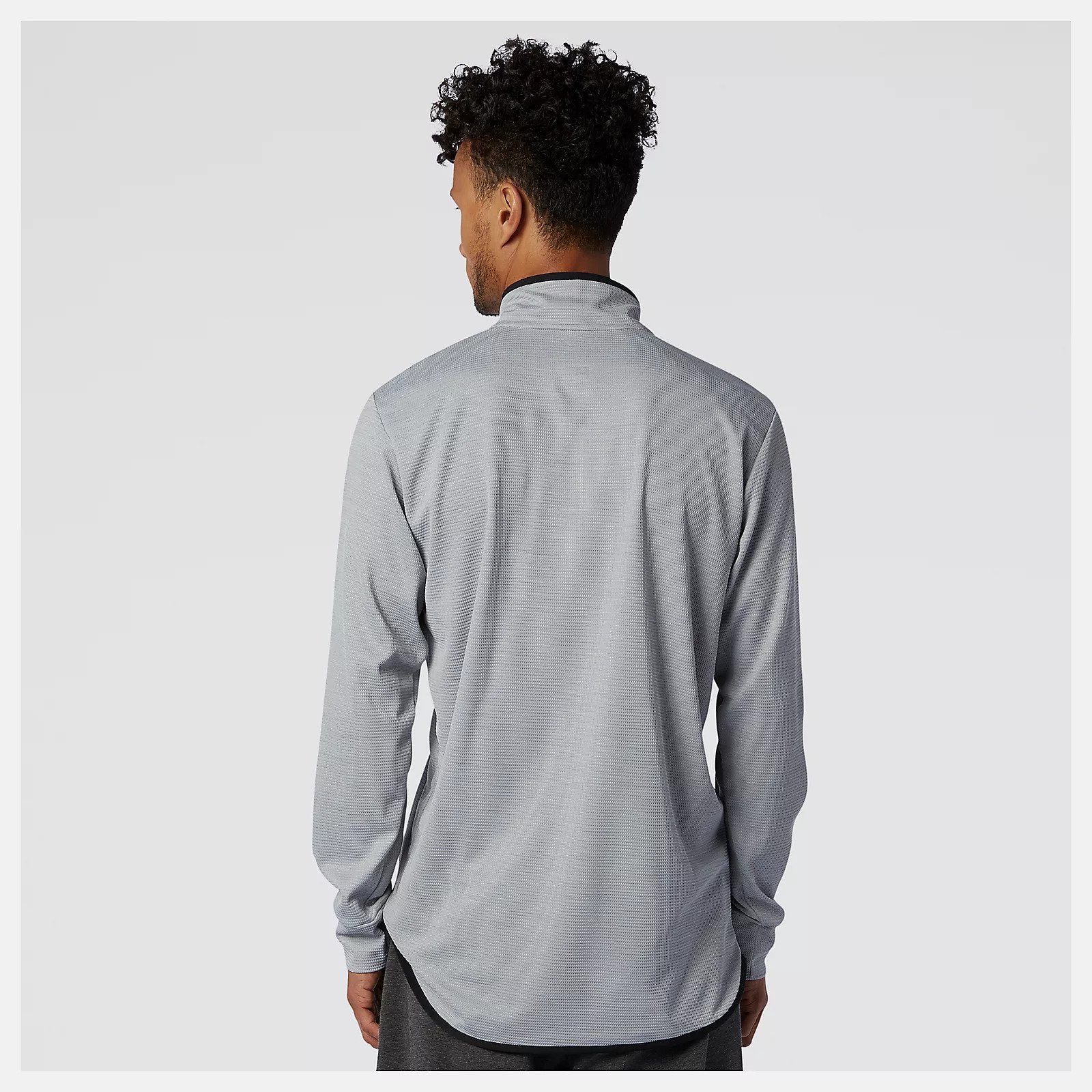 Back view of a model wearing the Men's Tenacity Quarter Zip by New Balance in the color Athletic Grey
