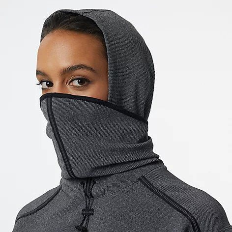 Zoomed in front view of a model wearing the Women's Q Speed Shift Hoodie by New Balance in the color Black Heather