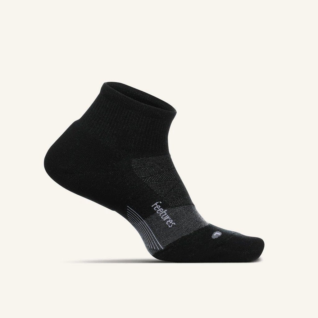 A lateral view of the Feetures Merino 10 Ultra Light Quarter Sock (left foot) in the color grey
