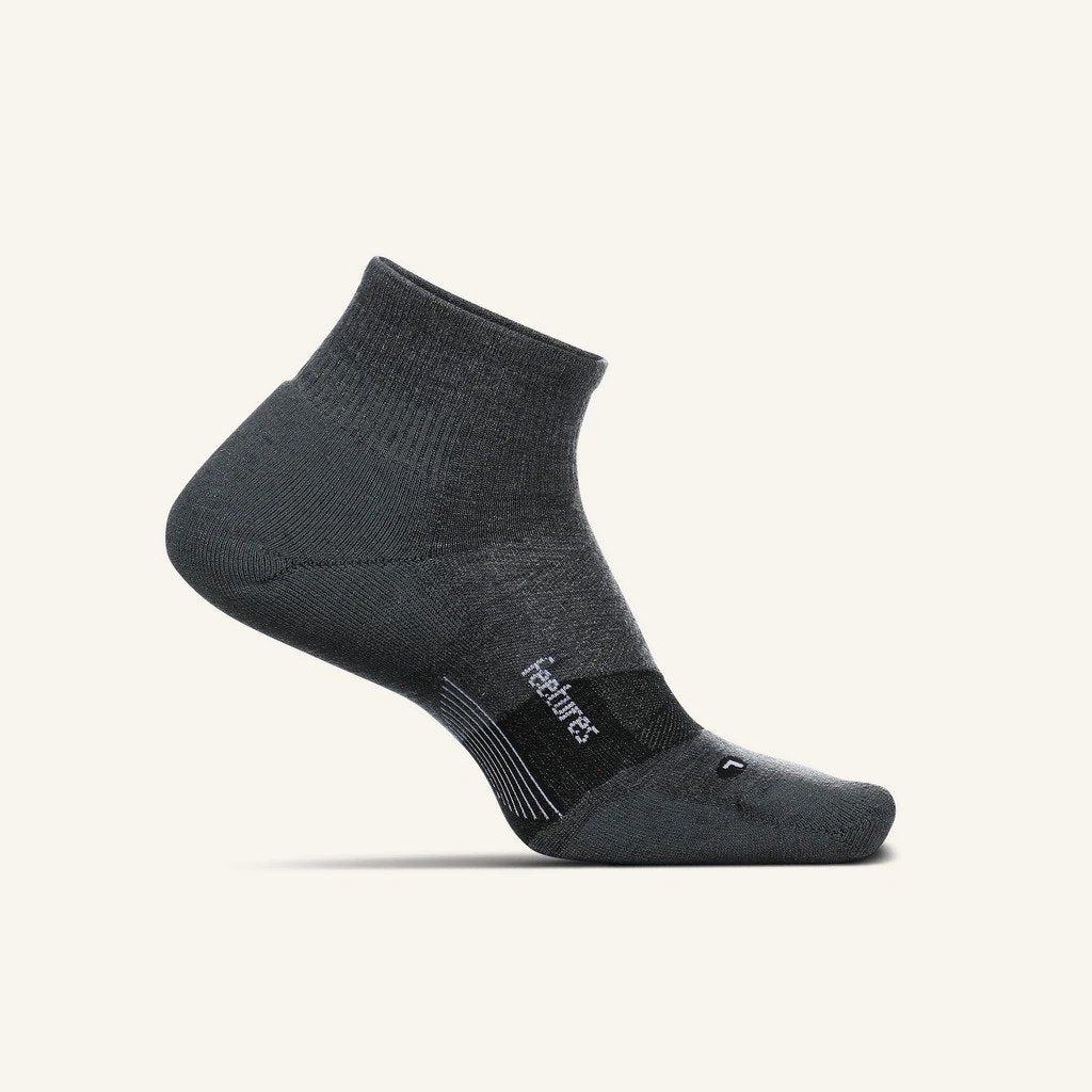 A medial view of the Feetures Merino 10 Cushion Quarter Sock (left foot) in the color grey