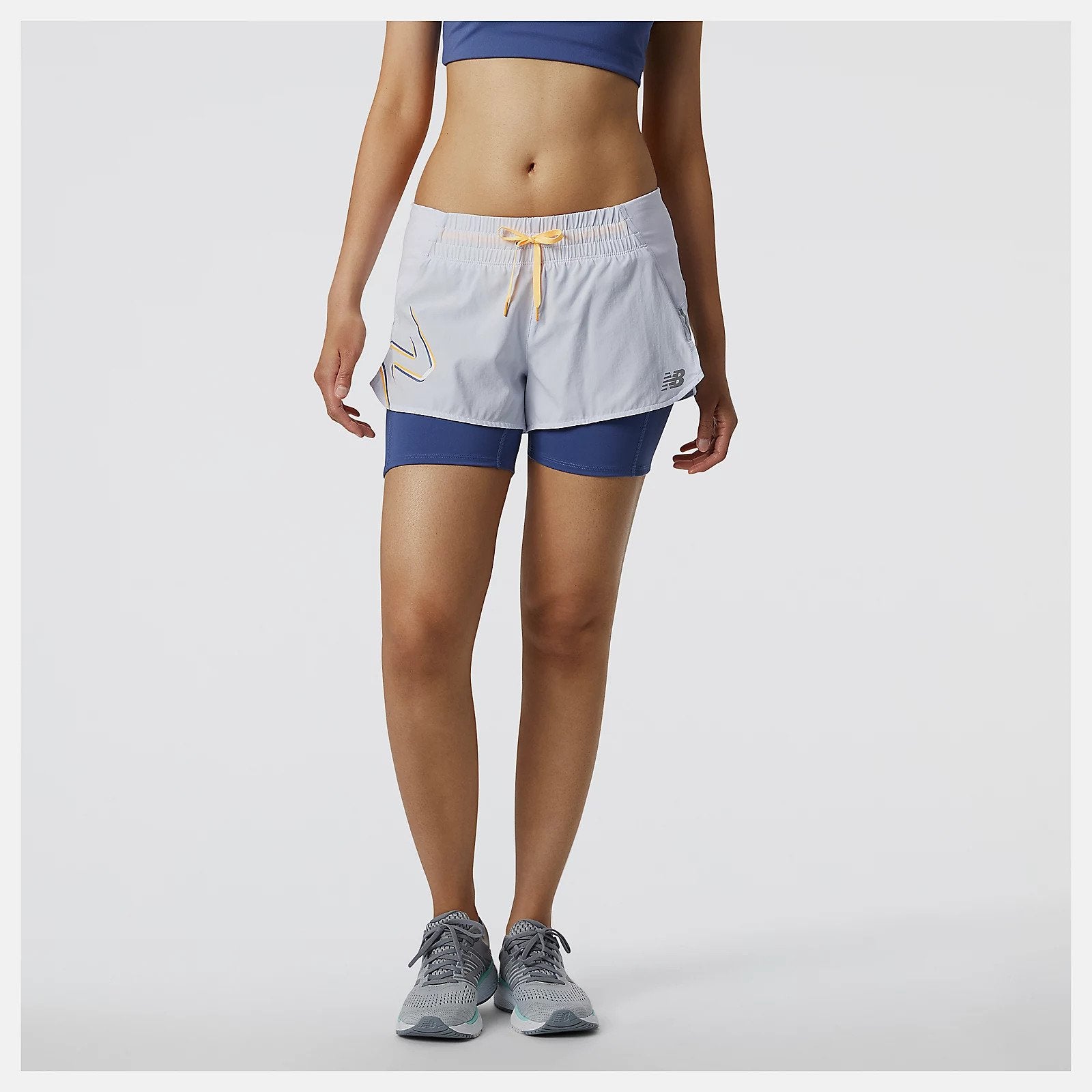 Featuring a lightweight woven shell and fitted inner short with NB DRYx wicking technology, our Printed Impact Run 2in1 Short helps you feel cool and dry on your run. These women's running shorts have a storage tunnel to thread extra layers through for a hands-free workout. Plus, a drop-in pocket on the inner fitted short offers quick access to nutrition and valuables. Finished with a print and reflective details for style