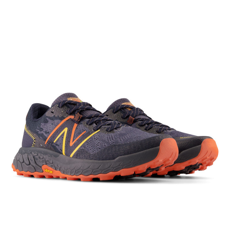 Front angled view of the Men's Hierro 7 trail shoe by New Balance in the color Thunder/Vibrant Orange/Apricot