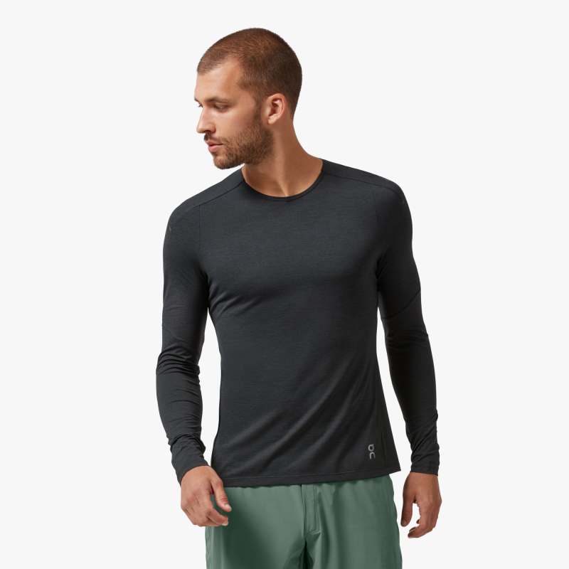 Front view of a model wearing the Men's Peformance Long Sleeve shirt by ON in the color Black