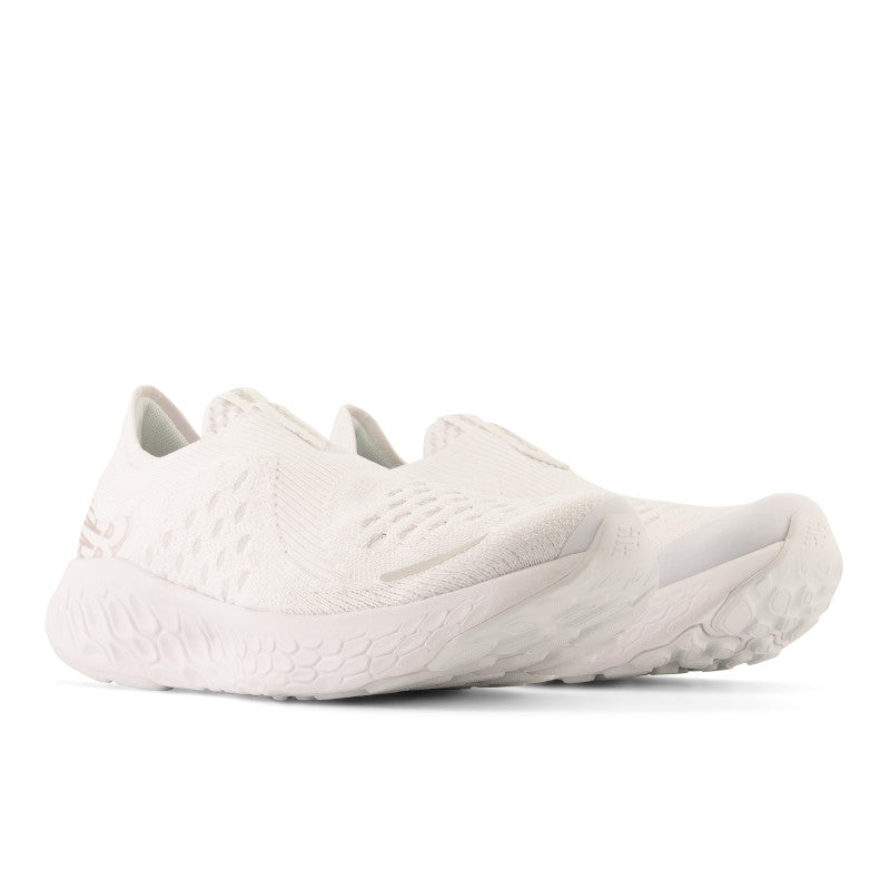 Front angled view of the Women's New Balance 1080 Unlaced in all white