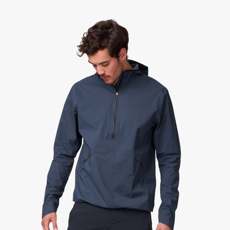 Front view of a male model wearing the Men's Waterproof Anorak by ON in the color Navy
