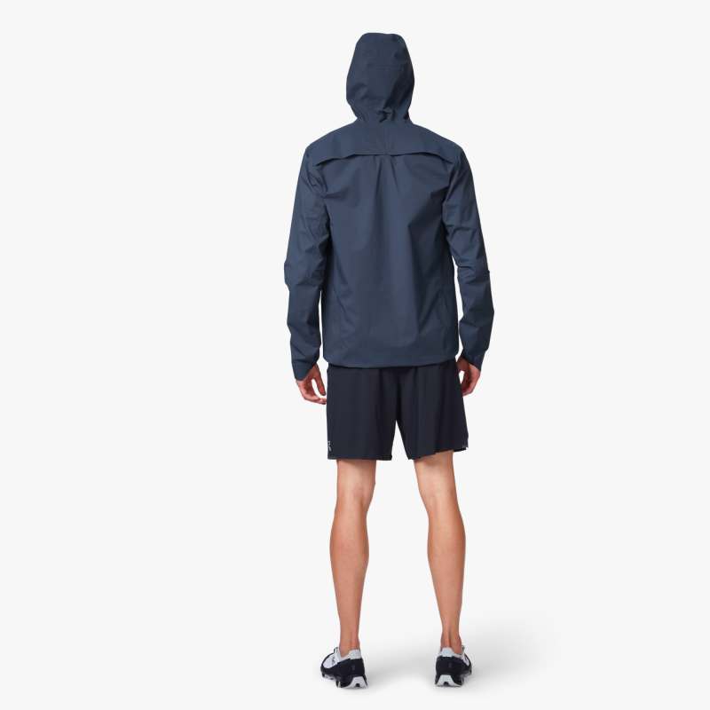 Back view of a male model wearing the Men's Waterproof Anorak by ON in the color Navy