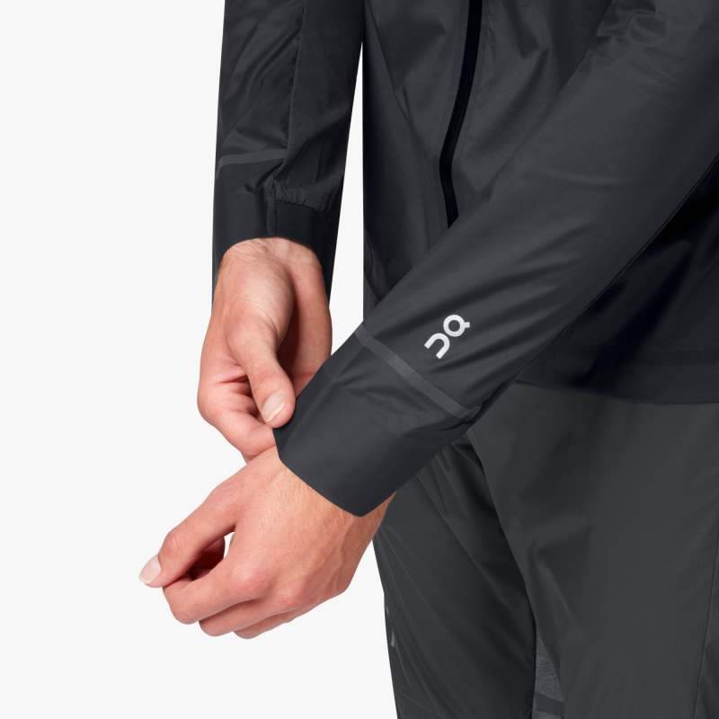 Zoomed in view of the left sleeve on a male model wearing the Men's Weather Jacket by ON in the color Black