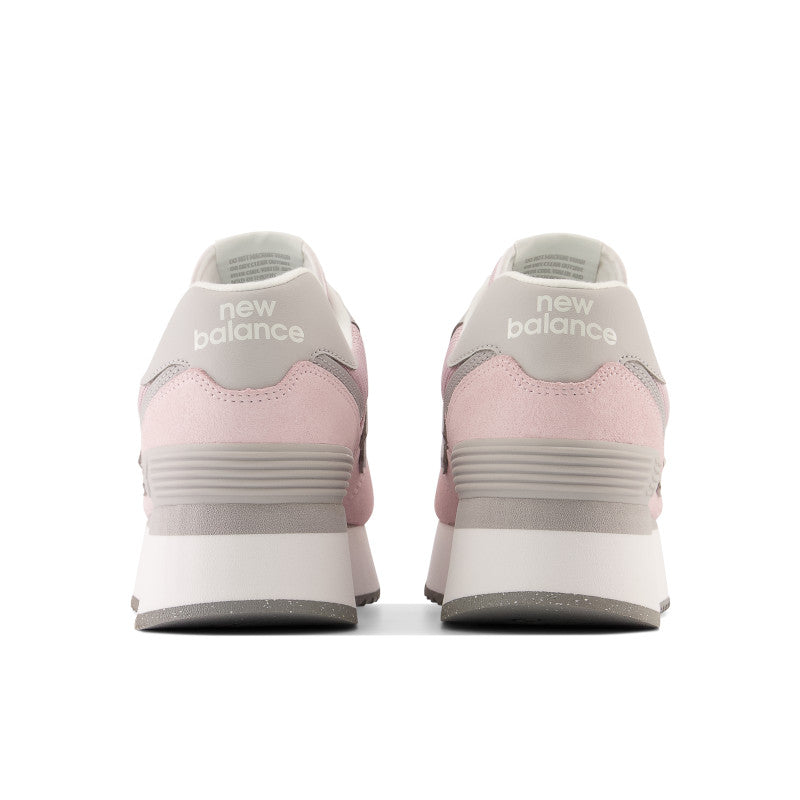 Back view of the Women's 574+ lifestyle shoe by New Balance in the color Stone Pink