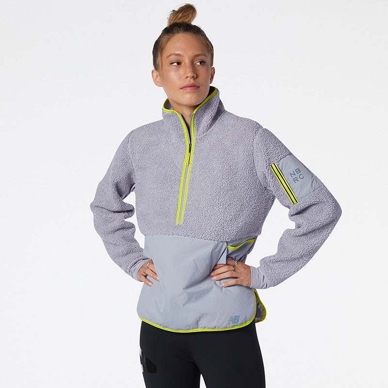 Front view of a model wearing the Women's Q-Speed Sherpa Anorak by New Balance in the color Grey