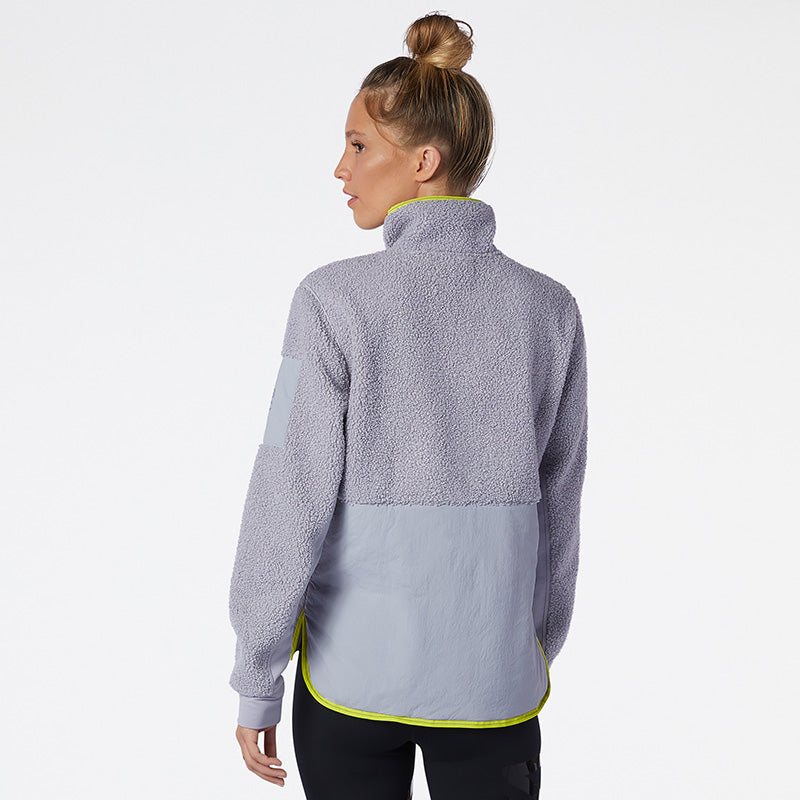 Back view of a model wearing the Women's Q-Speed Sherpa Anorak by New Balance in the color Grey